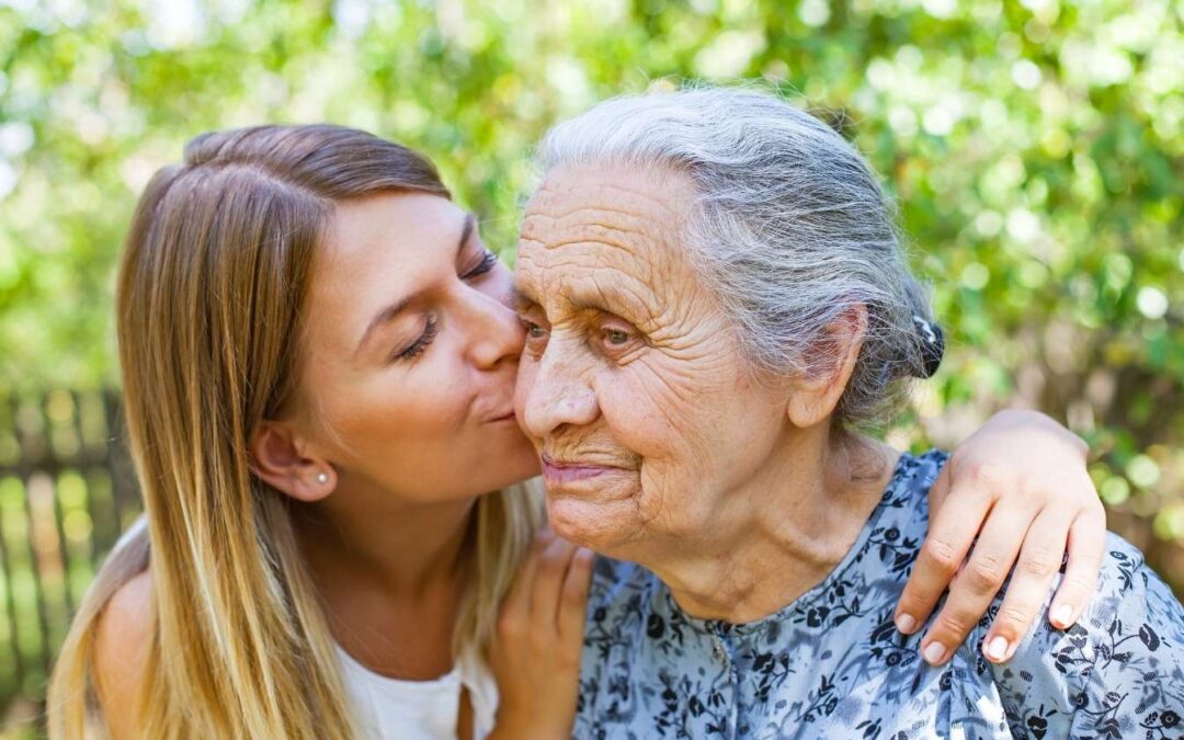 woman kissing grandma on the cheek