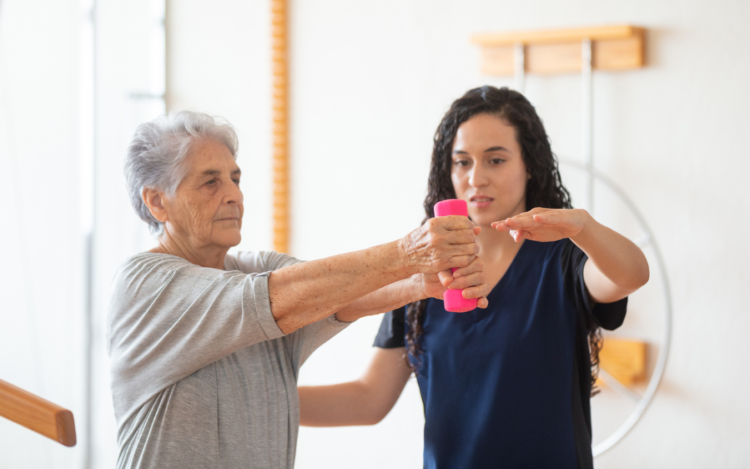 caregiver assisting old lady in her physical therapy